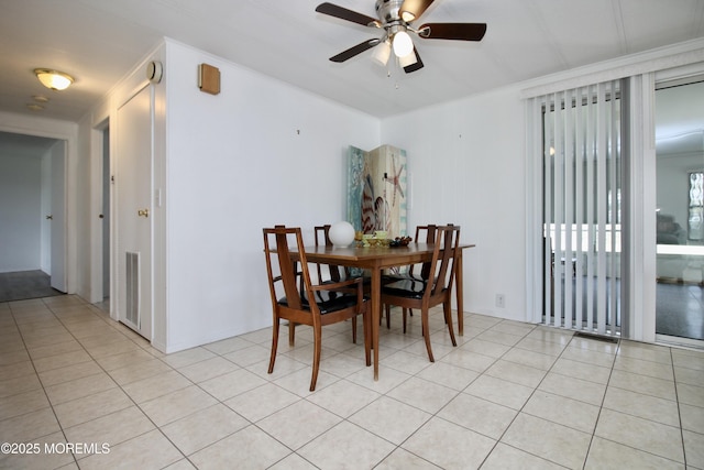 dining room with visible vents, a ceiling fan, ornamental molding, and light tile patterned flooring