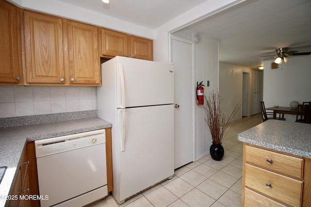 kitchen with light tile patterned floors, decorative backsplash, a ceiling fan, and white appliances