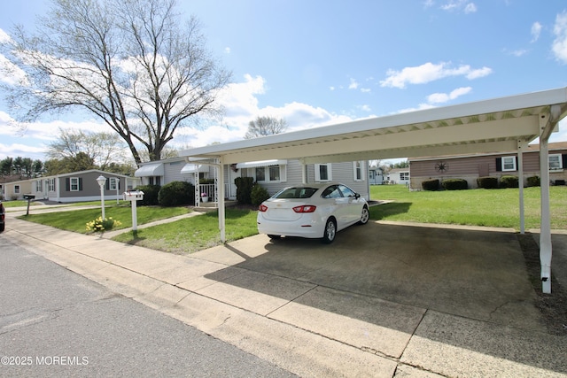 view of front of home featuring a carport, driveway, and a front lawn