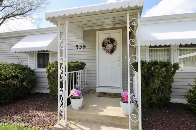 view of exterior entry featuring a porch
