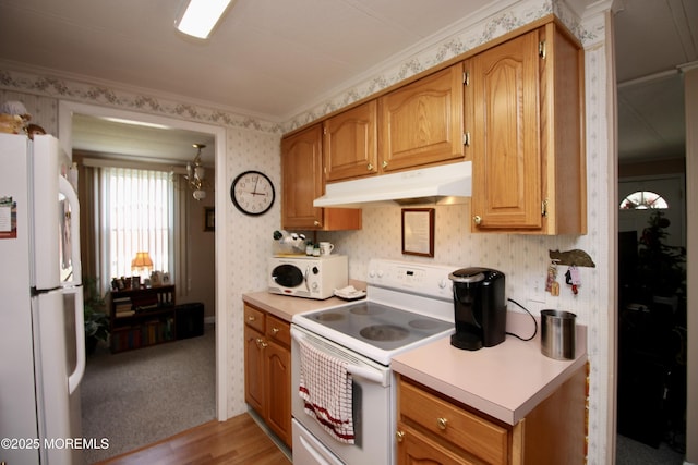 kitchen with wallpapered walls, light countertops, white appliances, and under cabinet range hood