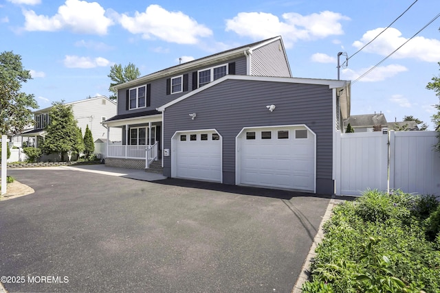 628 Morningside Ave, Union Beach, NJ 07735 - view of front of home with fence, asphalt driveway, a garage, and a porch