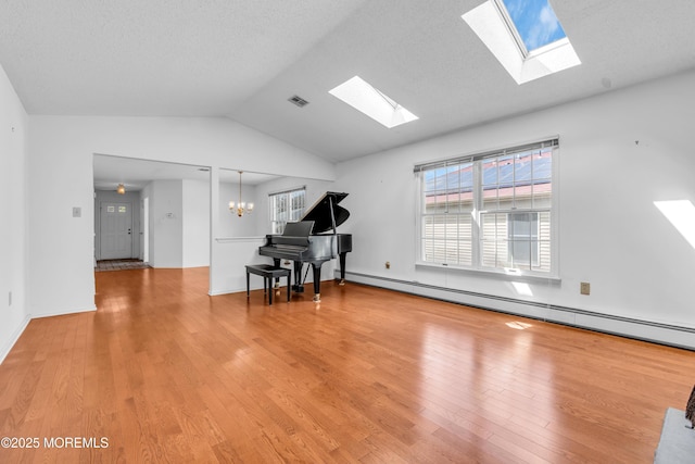 1905 Cherryvale Ct, Toms River, NJ 08755 - living room featuring a skylight, vaulted ceiling, light wood-type flooring, a chandelier, and a baseboard heating unit