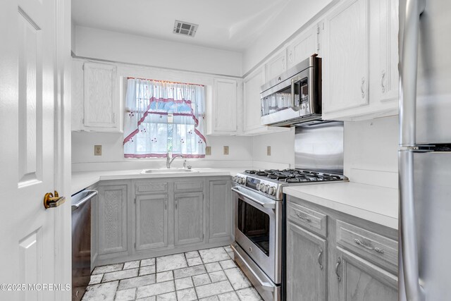1905 Cherryvale Ct, Toms River, NJ 08755 - kitchen with stainless steel appliances, light countertops, gray cabinetry, and light stone finish flooring
