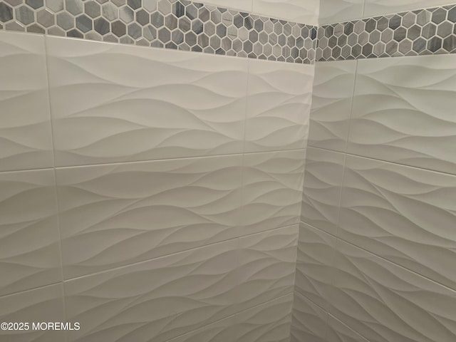 interior details featuring tiled shower