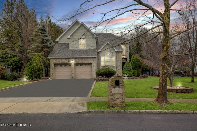 26 Kennedy Blvd, Old Bridge, NJ 08857 - traditional home featuring a front lawn, aphalt driveway, brick siding, and a garage