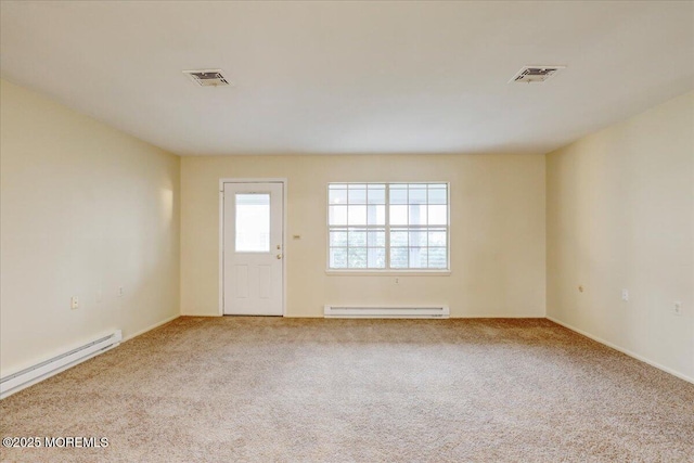 86E Dorchester Dr, Lakewood, NJ 08701 - carpeted empty room featuring visible vents, a baseboard heating unit, and baseboard heating