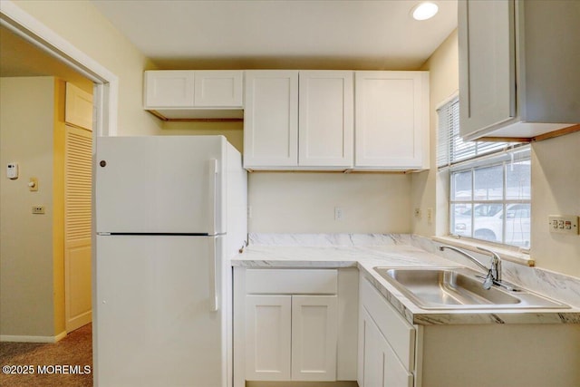 86E Dorchester Dr, Lakewood, NJ 08701 - kitchen featuring a sink, freestanding refrigerator, and white cabinetry