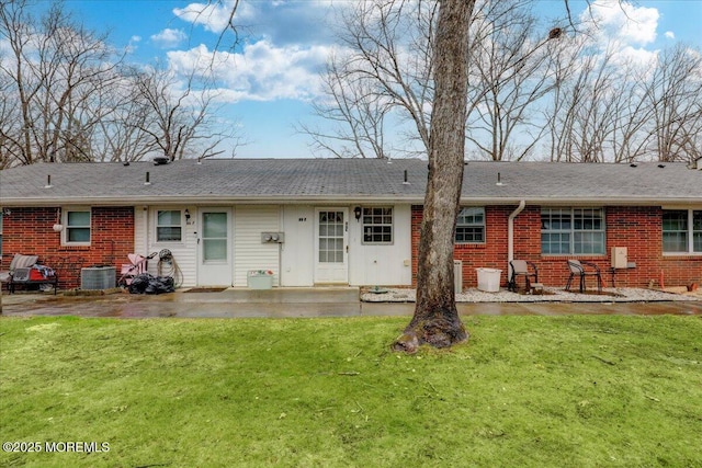 86E Dorchester Dr, Lakewood, NJ 08701 - back of house featuring brick siding, central AC, a patio, and a lawn