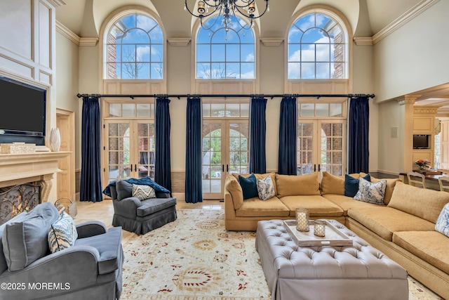 living area featuring french doors, a wealth of natural light, and a notable chandelier