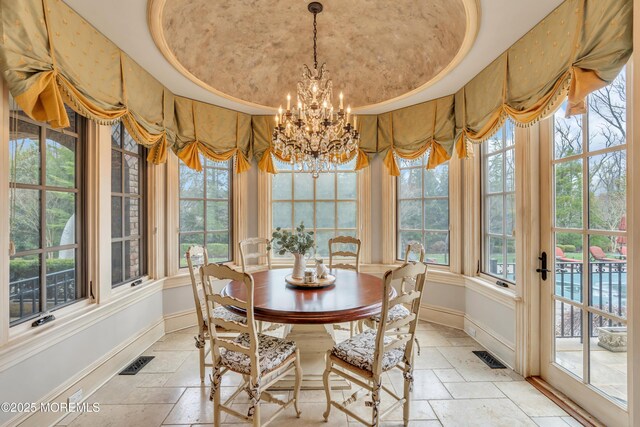 dining space with visible vents, baseboards, and stone tile floors