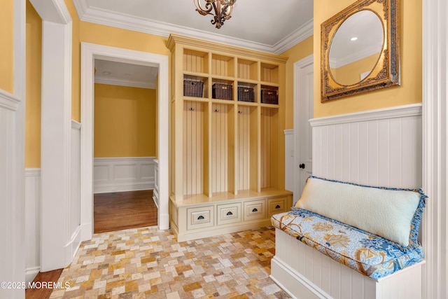 mudroom featuring ornamental molding and a wainscoted wall