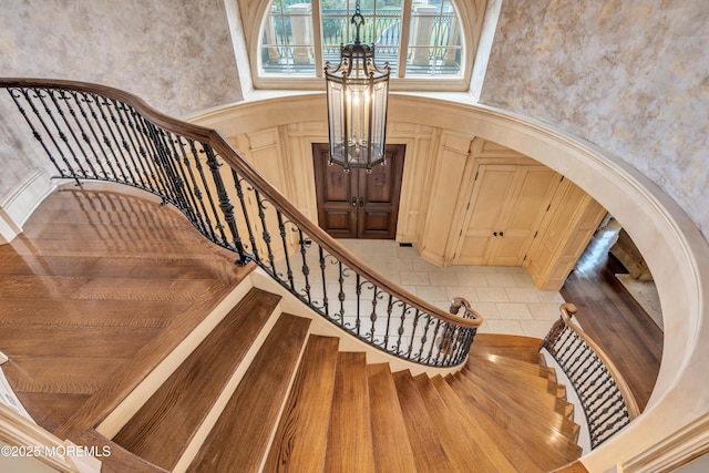 stairway featuring a high ceiling