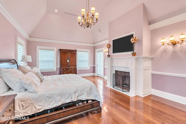 bedroom with a chandelier, wood finished floors, baseboards, and lofted ceiling