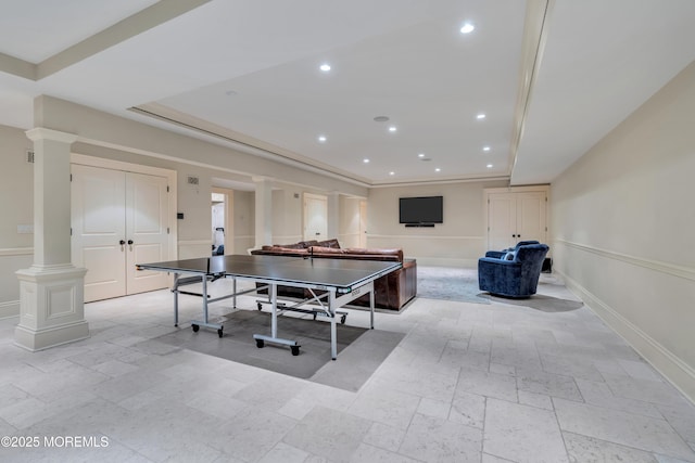 recreation room with decorative columns, recessed lighting, stone tile floors, and baseboards