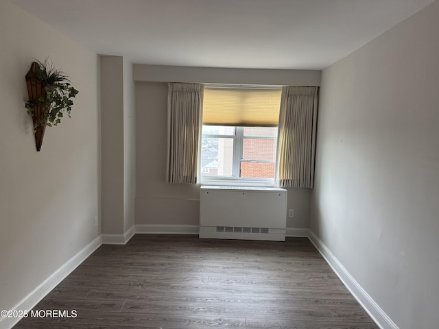 28 Riverside Ave Unit 4H, Red Bank, NJ 07701 - empty room with baseboards, dark wood finished floors, and radiator