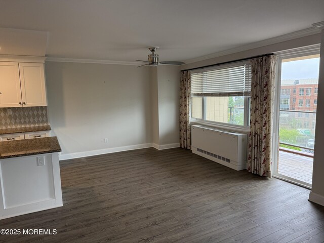 28 Riverside Ave Unit 4H, Red Bank, NJ 07701 - unfurnished dining area with crown molding, baseboards, ceiling fan, radiator heating unit, and dark wood-style floors