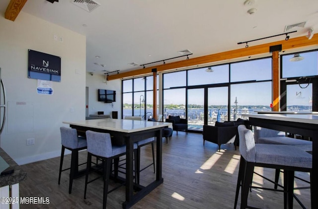 28 Riverside Ave Unit 4H, Red Bank, NJ 07701 - dining area featuring baseboards, visible vents, track lighting, and dark wood-type flooring