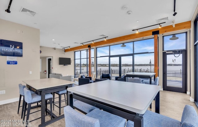 28 Riverside Ave Unit 4H, Red Bank, NJ 07701 - dining area featuring baseboards, rail lighting, visible vents, and light wood-style flooring