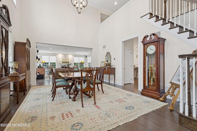 17 Spalding Dr, Holmdel, NJ 07733 - dining area with stairs, a high ceiling, dark wood finished floors, a chandelier, and arched walkways