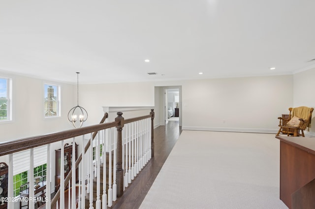 17 Spalding Dr, Holmdel, NJ 07733 - corridor with healthy amount of natural light, a chandelier, recessed lighting, ornamental molding, and dark carpet