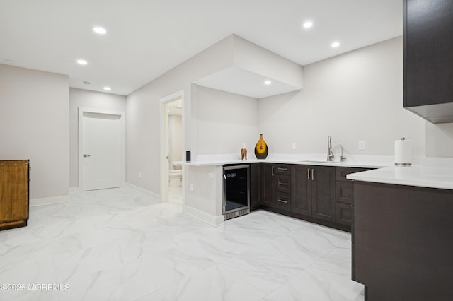 17 Spalding Dr, Holmdel, NJ 07733 - kitchen with wine cooler, light marble finish flooring, light countertops, recessed lighting, and dark brown cabinets