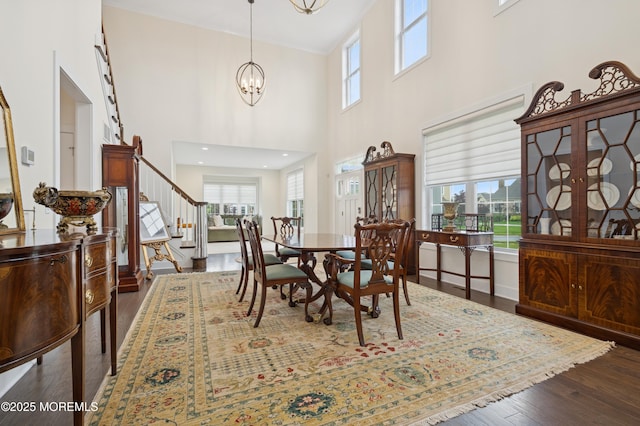 17 Spalding Dr, Holmdel, NJ 07733 - dining room with a high ceiling, healthy amount of natural light, stairway, dark wood-type flooring, and a chandelier