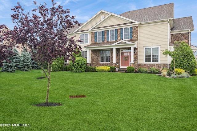 17 Spalding Dr, Holmdel, NJ 07733 - view of front of home featuring stone siding, a front yard, and roof with shingles