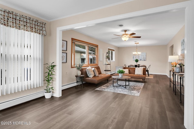 living area with a baseboard heating unit, baseboards, visible vents, a baseboard radiator, and wood finished floors