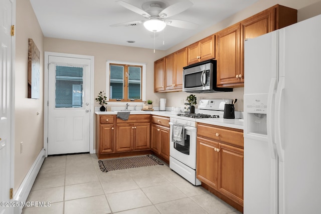 kitchen with white appliances, a ceiling fan, light tile patterned flooring, light countertops, and a baseboard radiator