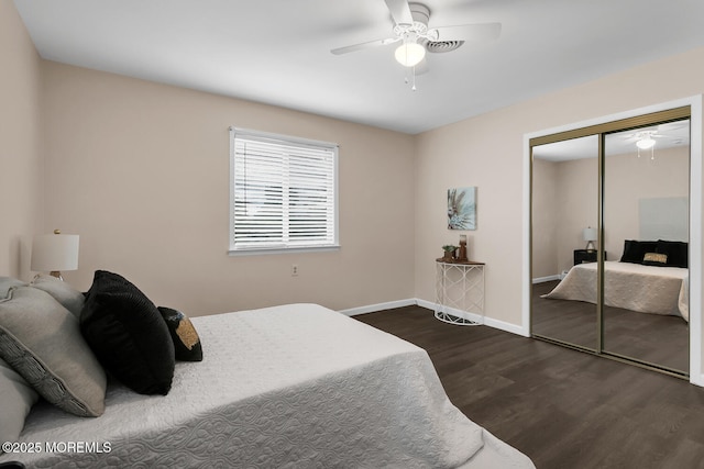 bedroom featuring dark wood-type flooring, a closet, baseboards, and ceiling fan