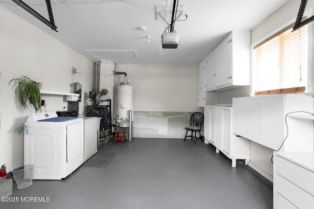 garage featuring water heater, washer and clothes dryer, and a garage door opener