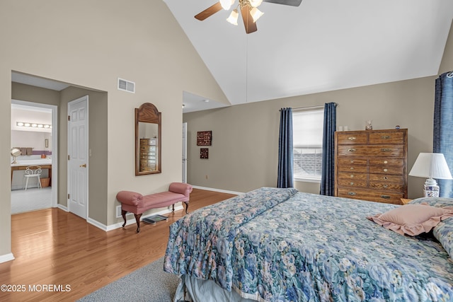 bedroom with wood finished floors, baseboards, ceiling fan, and high vaulted ceiling