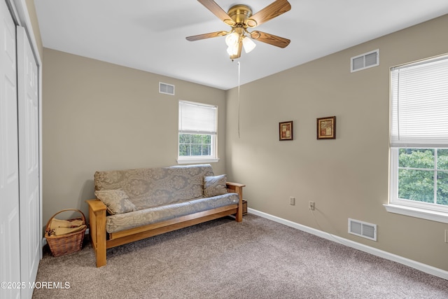 sitting room featuring a ceiling fan, carpet flooring, and baseboards