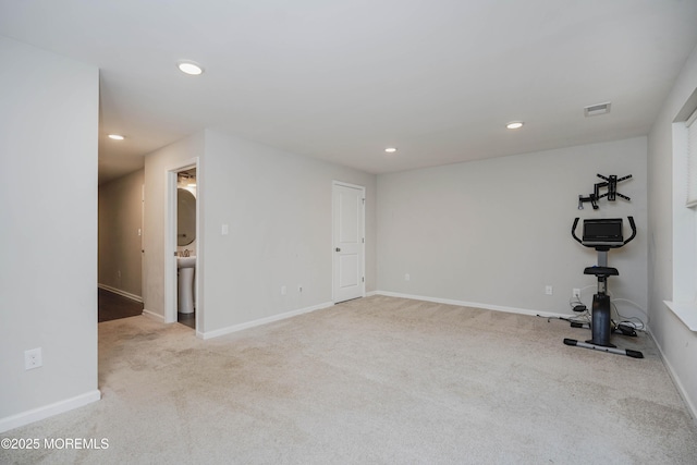 interior space featuring recessed lighting, visible vents, baseboards, and carpet floors