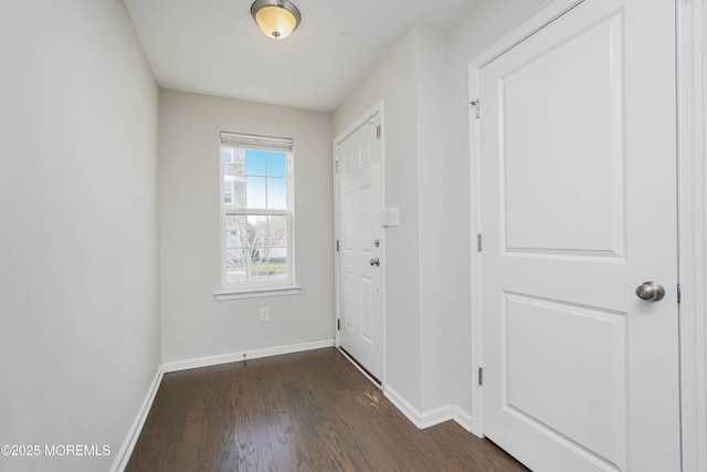 entryway featuring dark wood-type flooring and baseboards