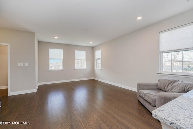 living room featuring baseboards, recessed lighting, and dark wood finished floors