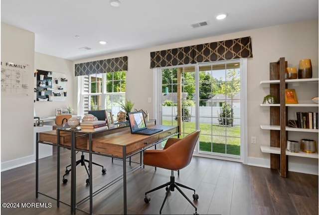 office featuring dark wood-type flooring, baseboards, visible vents, and recessed lighting