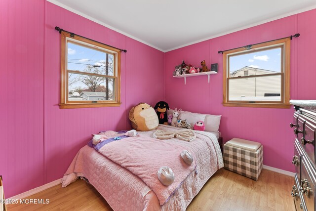 71 6th St, Belford, NJ 07718 - bedroom with light wood-type flooring, multiple windows, and baseboards