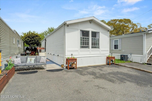 exterior space featuring central air condition unit and a patio area