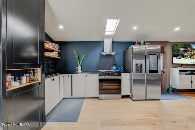 kitchen featuring open shelves, gas stove, wall chimney exhaust hood, stainless steel fridge with ice dispenser, and a skylight