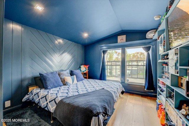 bedroom featuring hardwood / wood-style floors and lofted ceiling