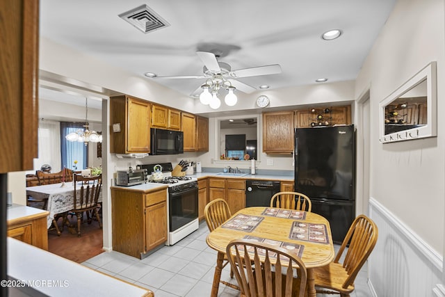55 Marc Dr, Howell, NJ 07731 - kitchen with black appliances, a sink, light tile patterned floors, brown cabinetry, and light countertops
