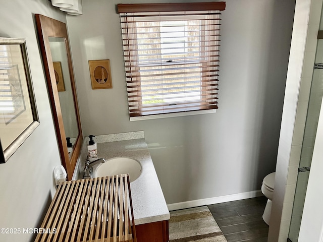 127 8th Ave, Seaside Park, NJ 08752 - full bathroom with vanity, toilet, baseboards, and wood finished floors