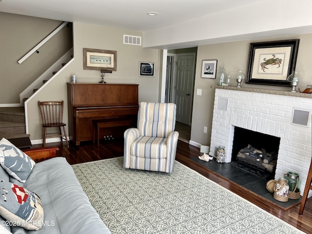 127 8th Ave, Seaside Park, NJ 08752 - living area with stairs, wood finished floors, a brick fireplace, and baseboards