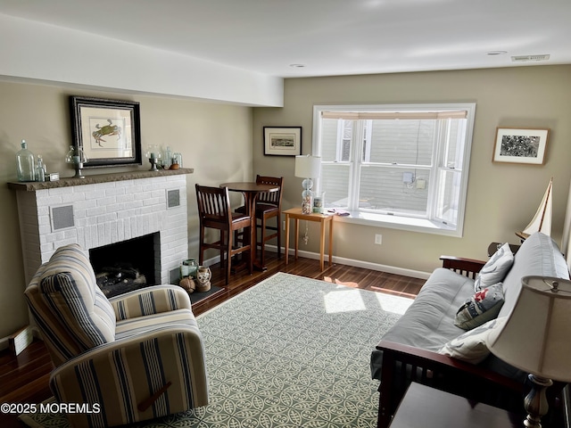 127 8th Ave, Seaside Park, NJ 08752 - living room with wood finished floors, a brick fireplace, and baseboards