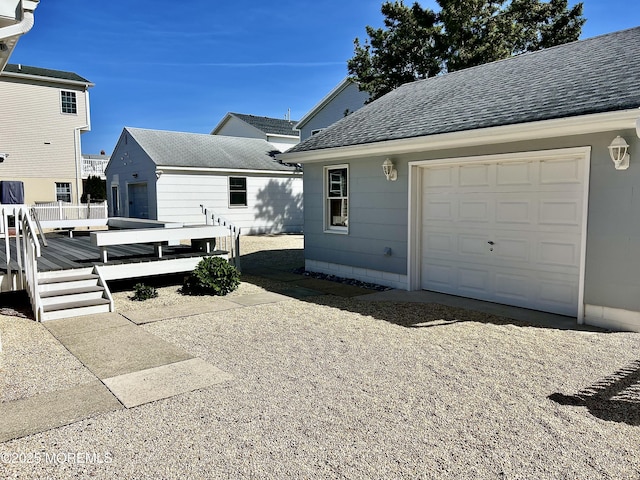 127 8th Ave, Seaside Park, NJ 08752 - view of side of property featuring a shingled roof, a wooden deck, and an outdoor structure