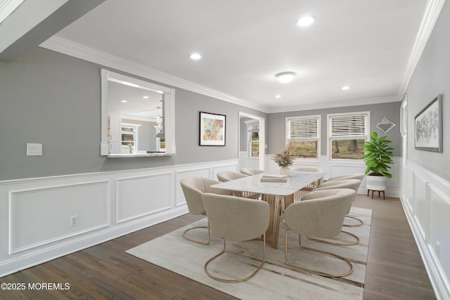 dining area featuring crown molding, recessed lighting, and a decorative wall