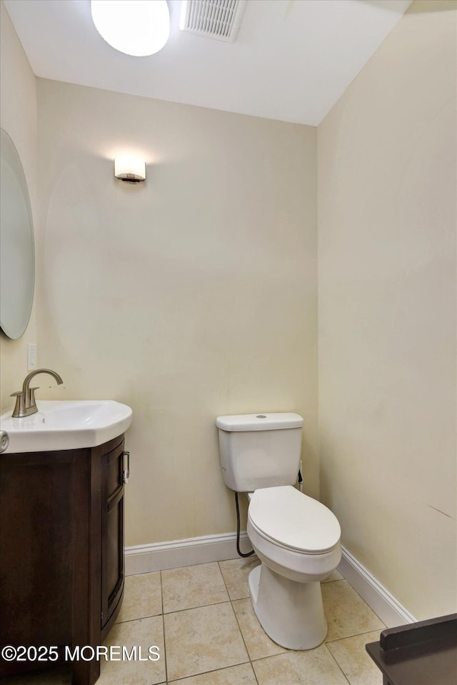 half bath featuring toilet, vanity, tile patterned flooring, and visible vents