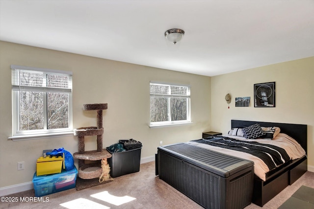 carpeted bedroom featuring baseboards